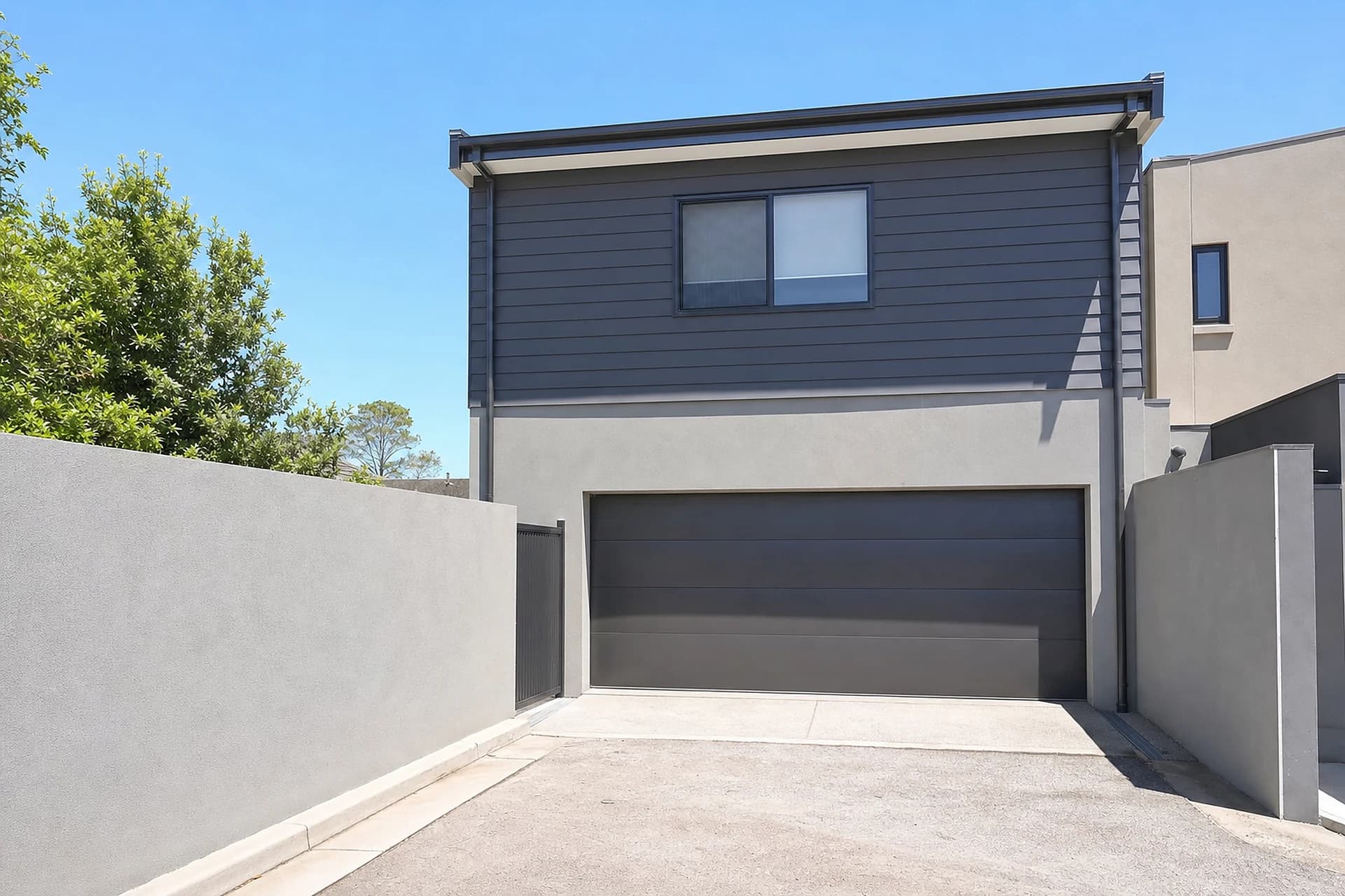 A rear laneway garage behind a two storey Butler home, the shopper's entry side that most quotes forget