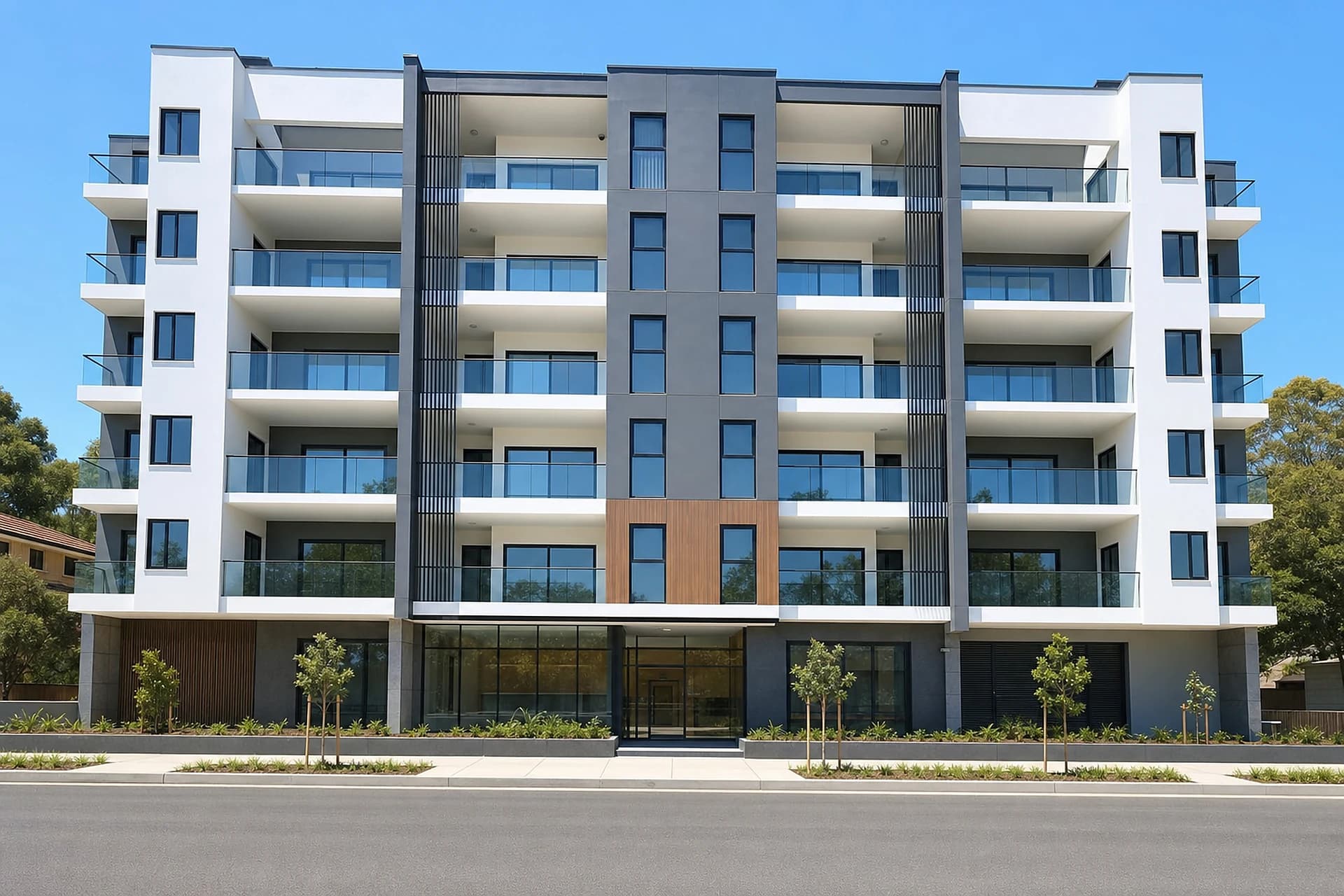 A modern residential apartment building in Cannington with glass balustrade balconies stacked up the facade