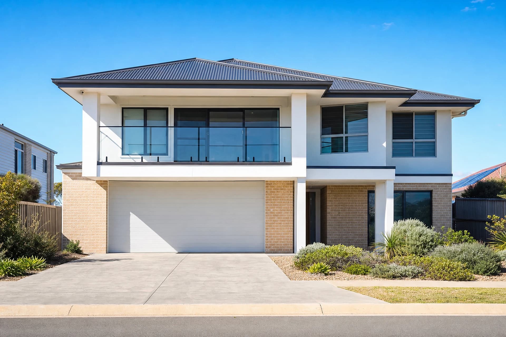 An empty two storey coastal estate home in Secret Harbour with a glass balustrade balcony, ready for handover