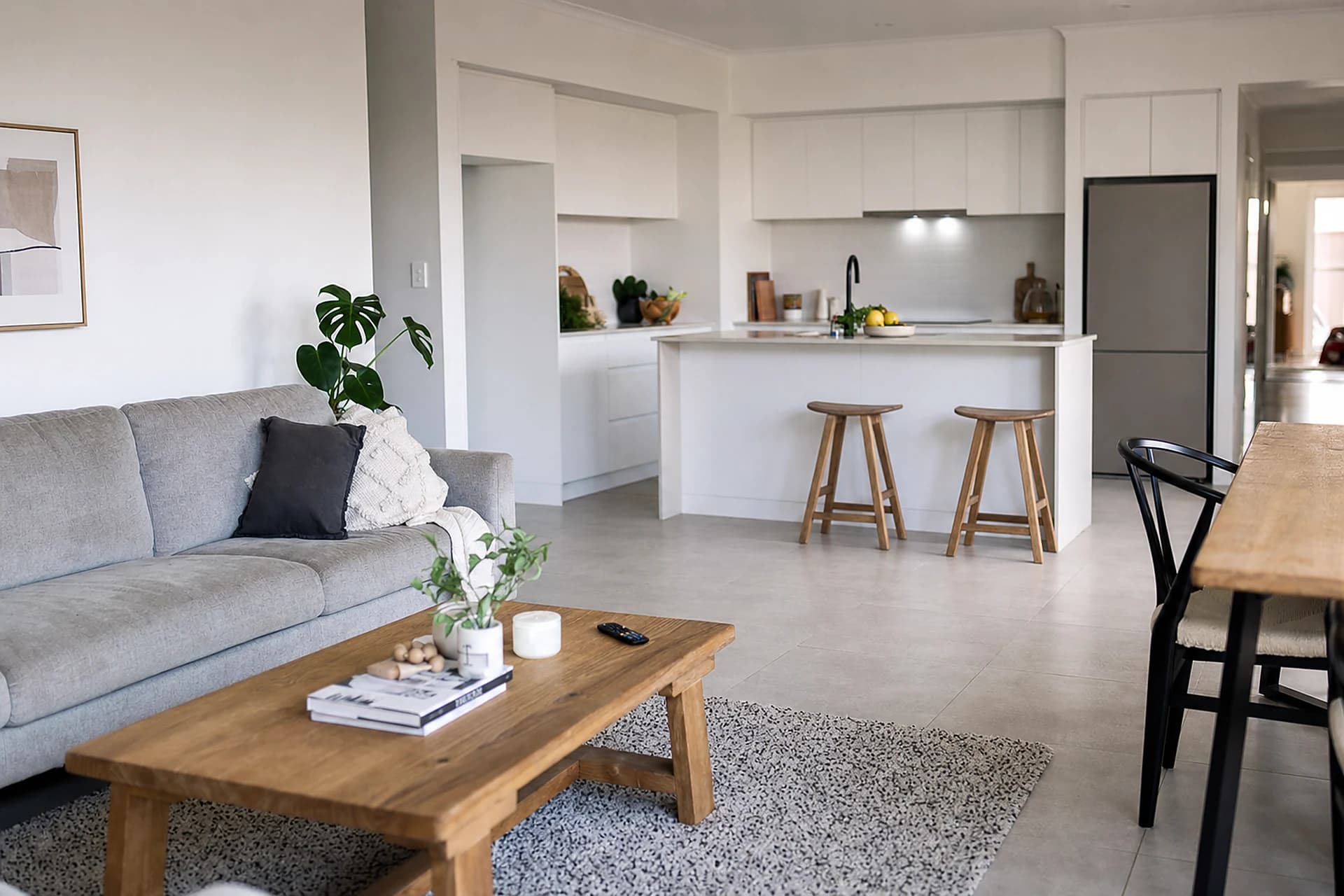 A clean, lived-in open plan kitchen and living area in a Perth home in midday light