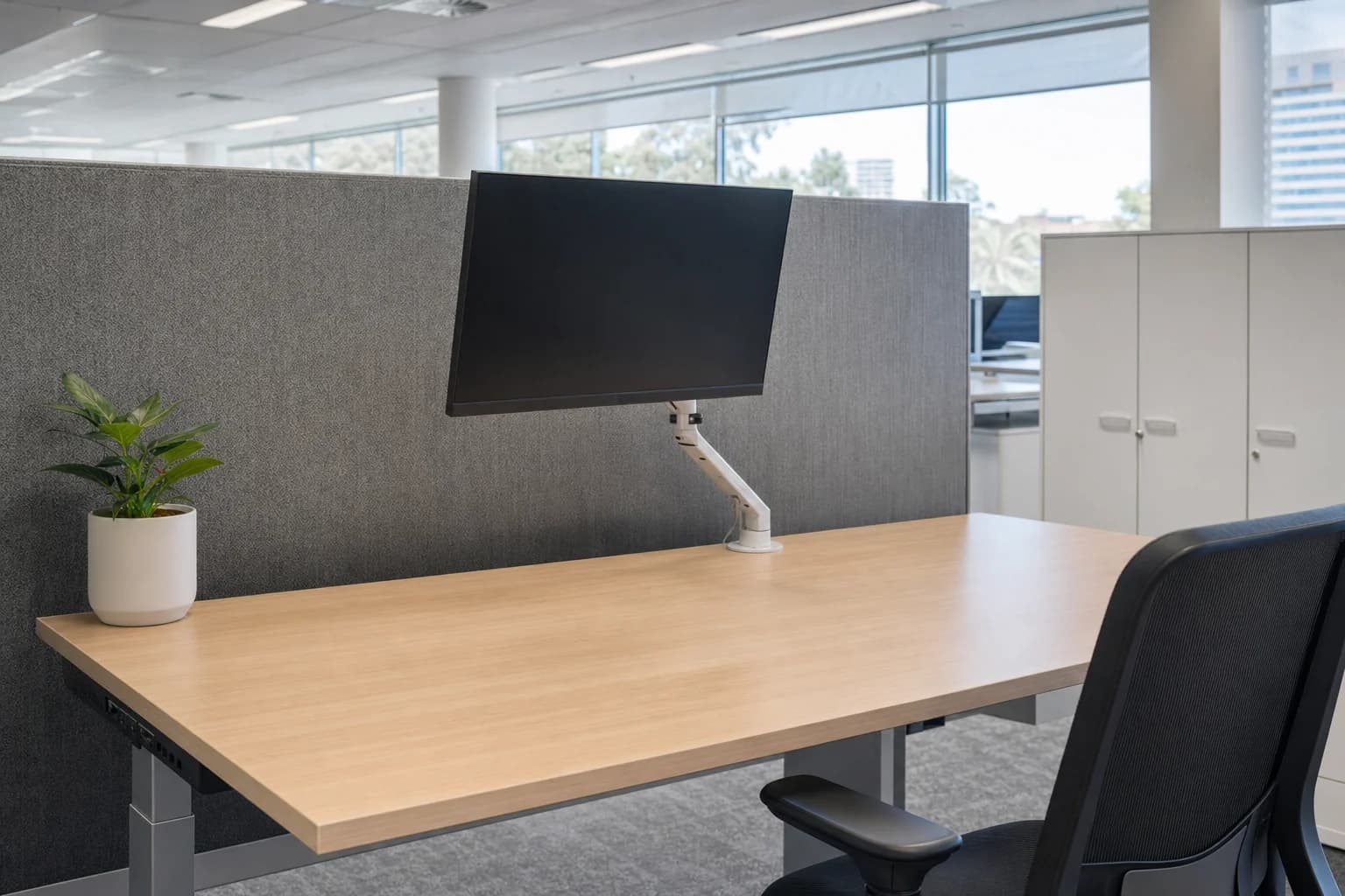 A cleared and wiped office workstation with the monitor switched off